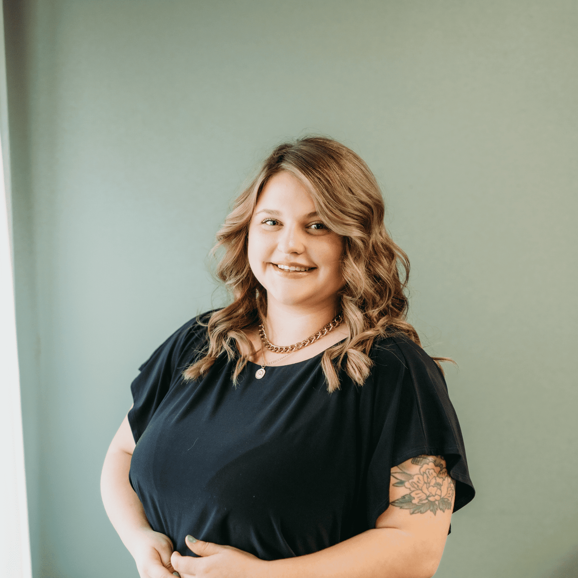 Portrait of Kyra Goddard, a professional stylist at Tangles Salon, showcasing their expertise and style.